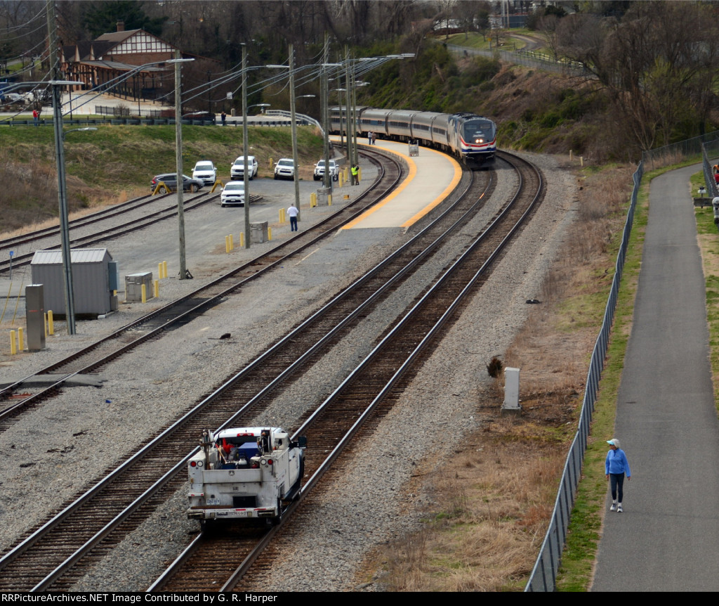 M of W hi-railer on #2 track closes in on Amtrak Crescent, train #20, making his station stop at "LYH" on Track #1 